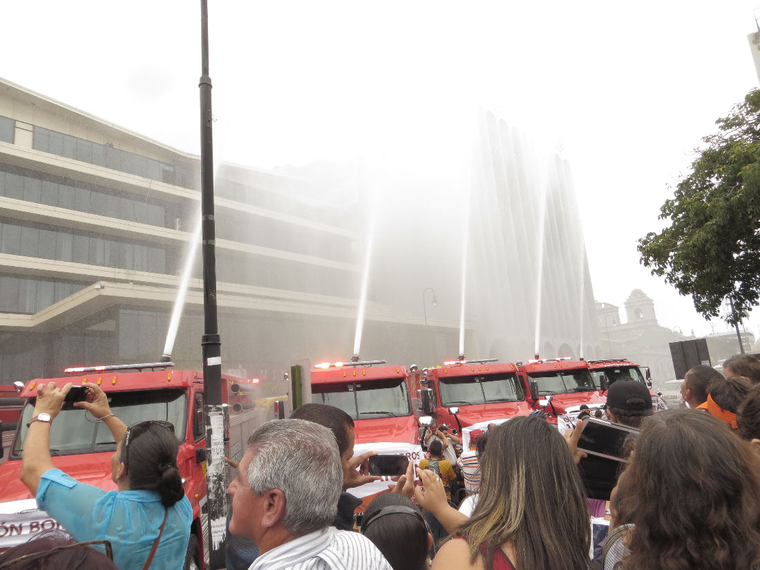 After the blessing of the fire trucks, the firemen let loose with their sirens and shot a spray of water into the air.