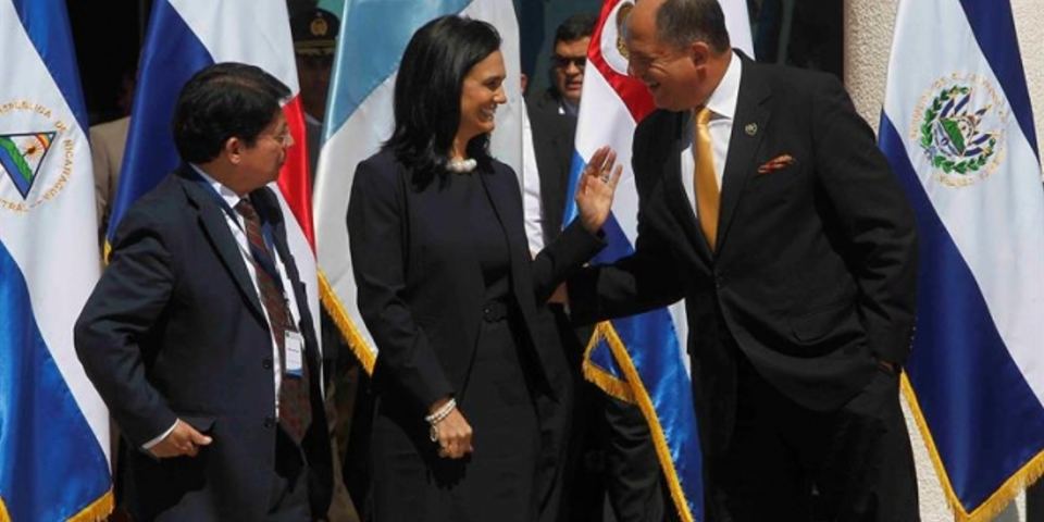 In El Salvador, President Luis Guillermo Solis exchanges words with Panama's vice-president, Isabel De Saint Malo, while Nicaragua's deputy foreign minister, Dennis Moncado, looks on.