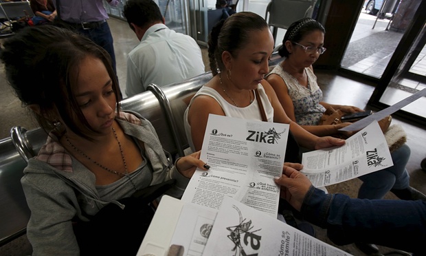 Colombian women listen as a health worker distributes information how to prevent the spread of the Zika virus in Bogota on Sunday. Photograph: John Vizcaino/Reuters