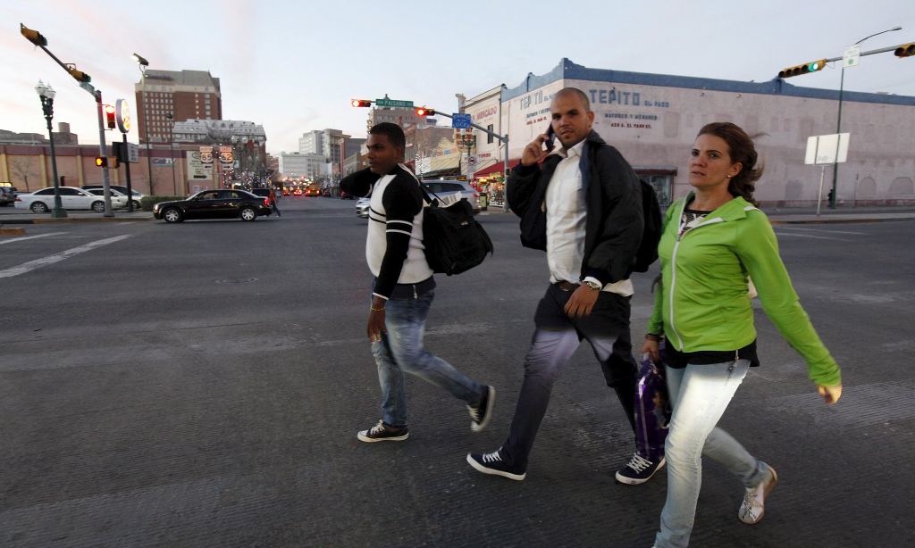 Cuban migrants walk on a street after travelling from Panama to Mexico and the US, as part of a pilot programme agreed by Central American countries. Photograph: Jose Luis Gonzalez/Reuters 