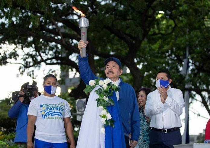 Maskless Ortega receives the Torch of Independence and raises Nicaragua flag